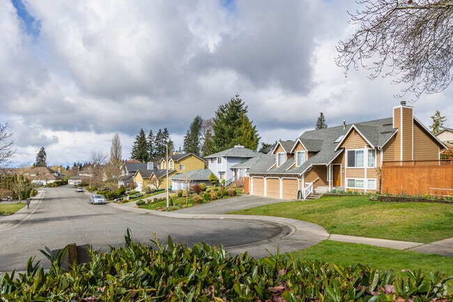 The homes in Spruce Hills often have large driveways and well maintained front lawns.
