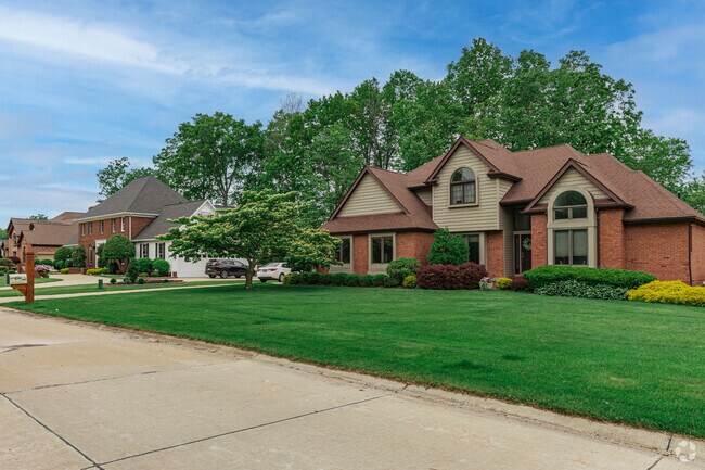 A row of stately homes winds down Hunting Lane, in the heart of Quail Hollow.