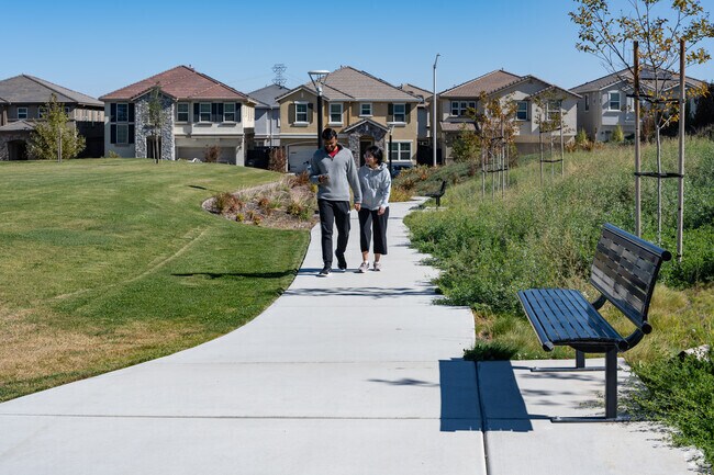 Residents enjoy walking at San Marco Hills Park which includes shade canopies and a playground.