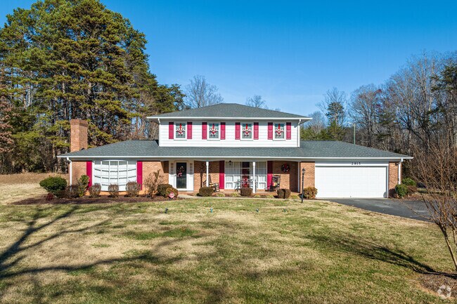 In Moravian-Baywood, a ranch home with a hipped roof is adorned for the holiday season.