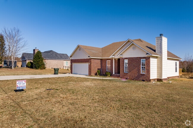 A row of smaller brick ranch-style homes in Ready Crossing.