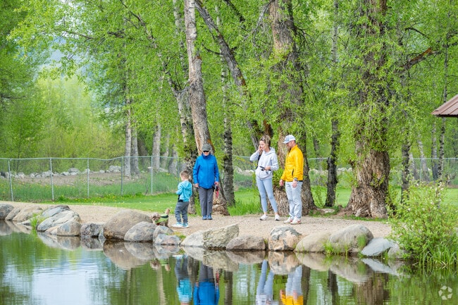 Kaibab Park in Granby features a youth fishing pond reflecting surrounding trees on its surface.