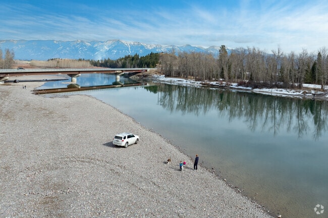 Evergreen families enjoy the Flathead River bank for running dogs and skipping rocks at the Old Steel Bridge Fishing Access.