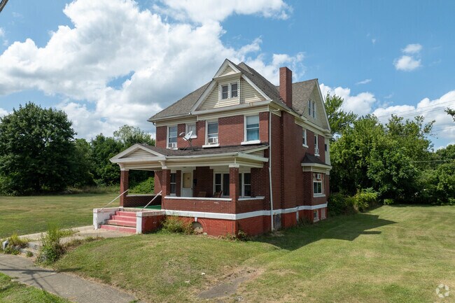 AS large brick Colonial home surrounded by empty lots in the Erie neighborhood.