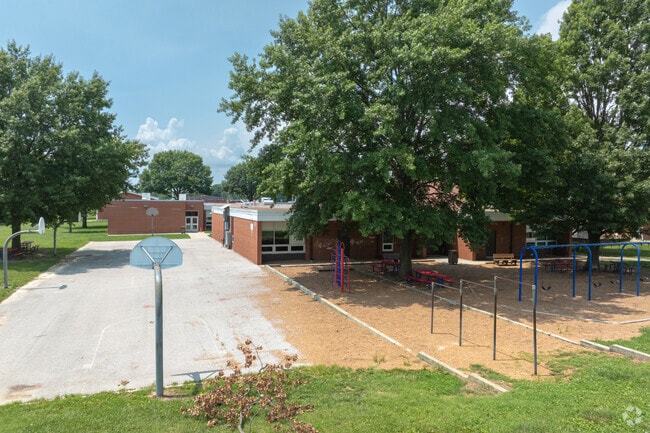 A small parking lot serves at a basketball court for students at Abraham Lincoln Elementary.