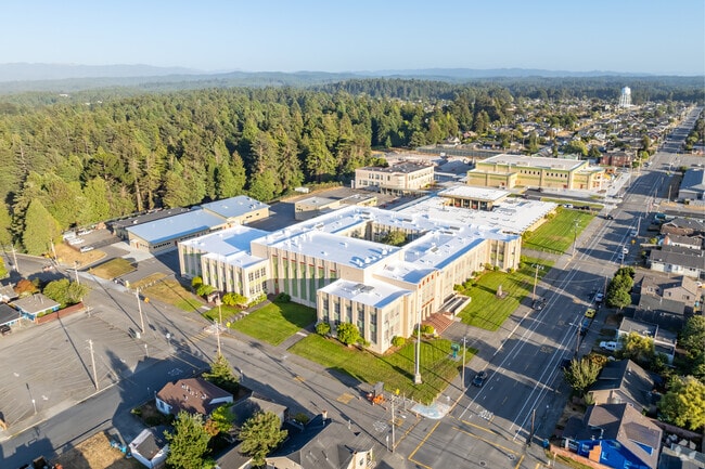 Eureka High School is surrounded by tall trees.