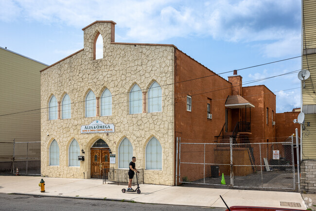 Children are seen playing by the Alpha & Omega Christian School in Newark, NJ.