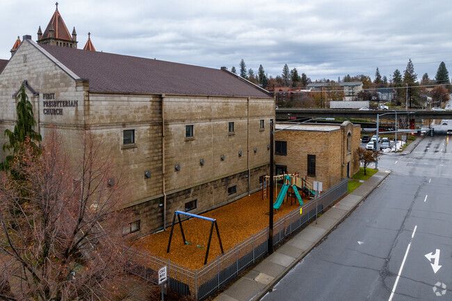 First presbyterian Christian school features a small playground on the side of the building.
