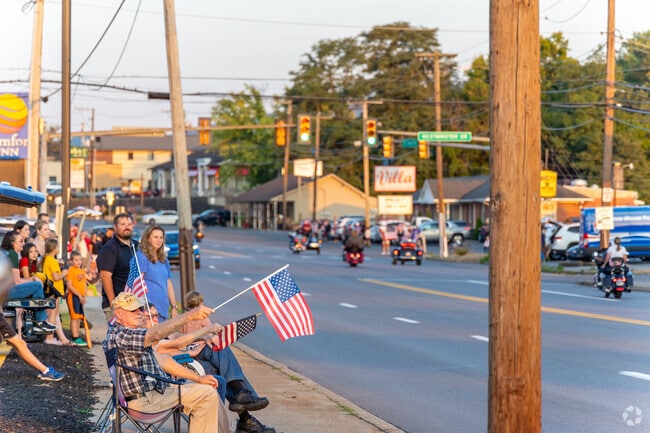 Locals set out chairs and bring their flags to show support for the 9/11 Memorial Bike Ride parade.