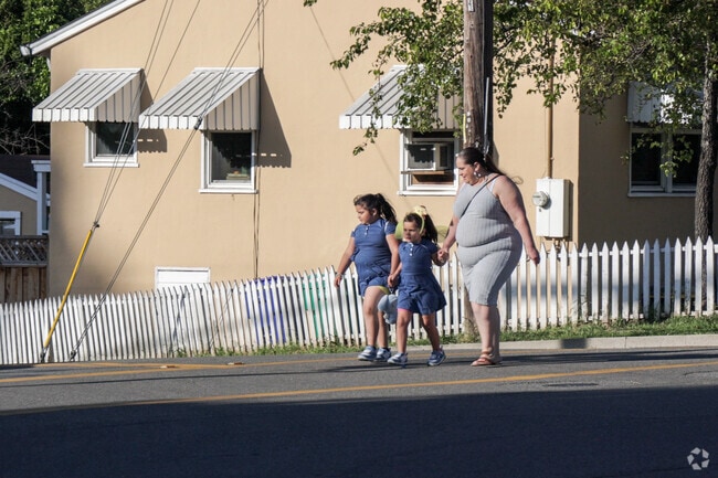 People enjoy an afternoon walk in the Fairview neighborhood.
