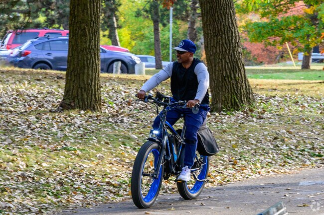 A cyclist enjoys an autumn ride along the Lansing River Trail in Old Town.