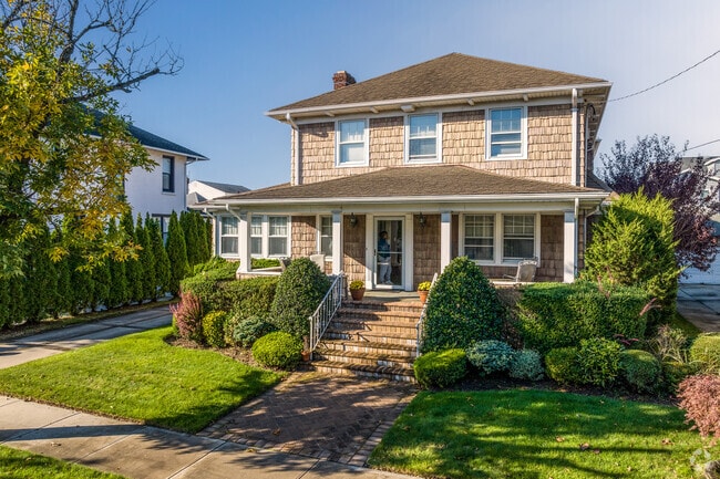 Nesponsit landscaping surrounds this home with a mix of well tendered gardens.