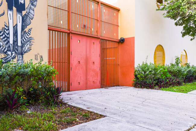 Bright red gates welcome students to Allapattah's Santa Clara Elementary.