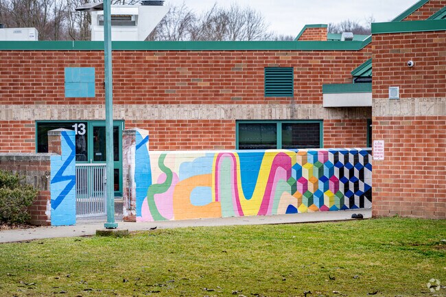 A colorful wall is decorated at this entrance to Trinity North Elementary School.
