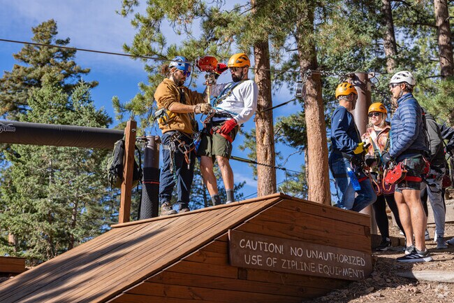 A group of visitors to Deer Creek brave the zipline at Beaver Ranch Park.