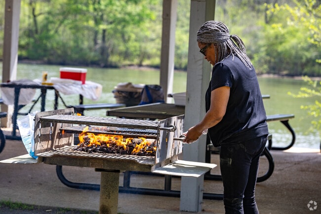Cooking up a feast in the great outdoors, enjoying the view and the fresh air alongside the Chattahoochee River.