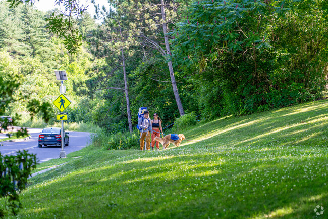 A family walks with their dog along a trail in Riverside.