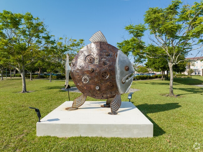 A metal fish sculpture adorns the lake shores.