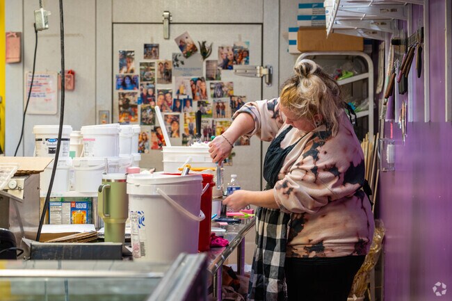 A baker crafting the perfect cake at Amy's Custom Cakery in Dover.