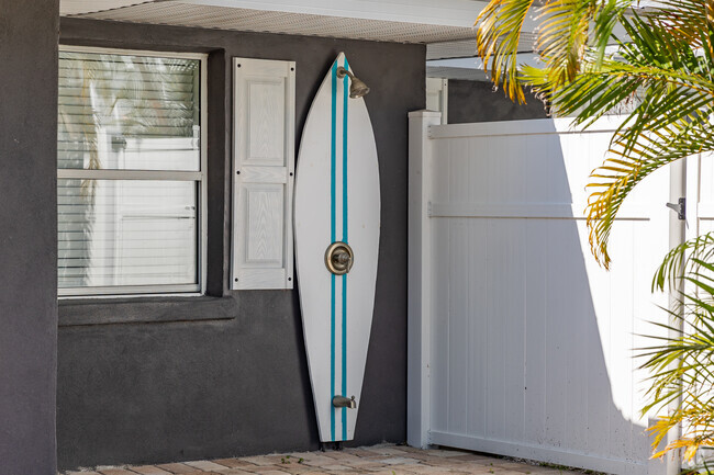 A cool surfboard outdoor shower to wash the sand of in Bradenton Beach.
