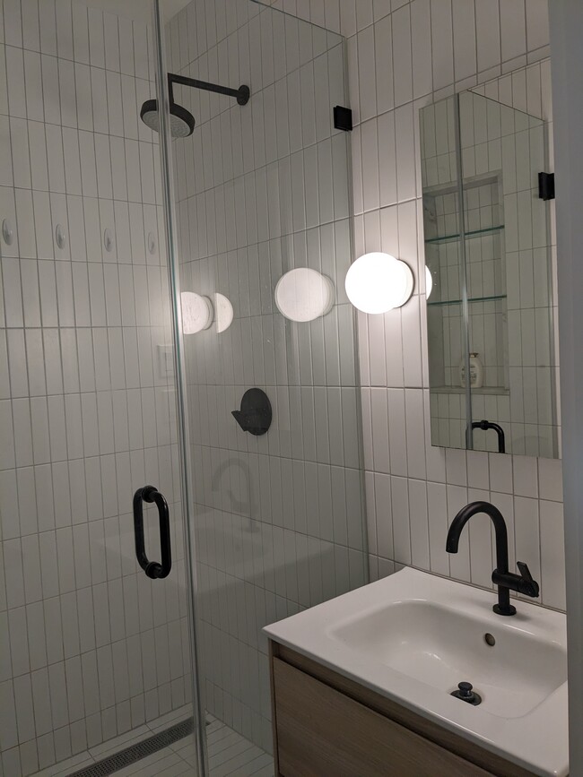 Bathroom has a walk-in shower and low-flow toilet.