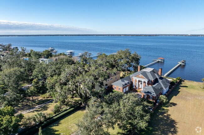 Stunning waterfront homes are shaded with beautiful mature oak trees.
