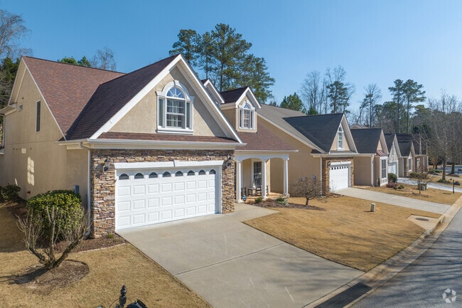 Homes in Peachtree City feature attached car garages and shallow front lawns.