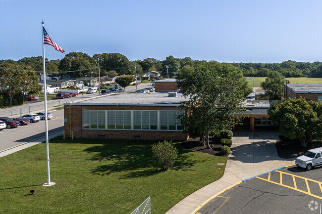 The main entrance has the flagpole near by.