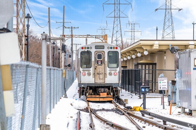 A yellow line train sits at the station on Dempster Street in Skokie, IL.