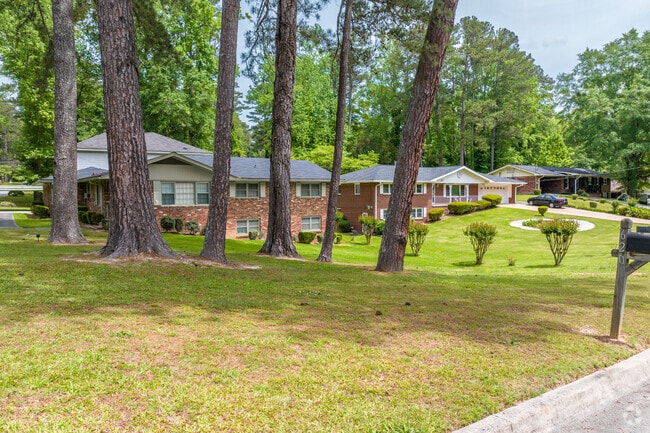 Tall pine trees provide a natural anopy over brick ranch homes in Peyton Forest.