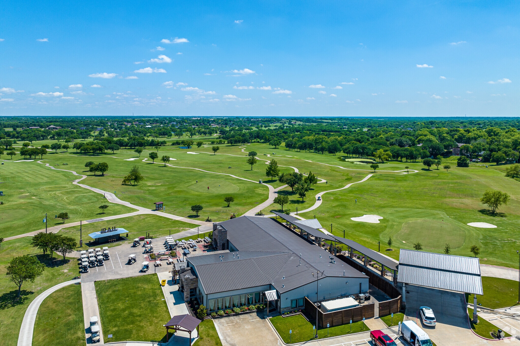 The scenic Rusted Rail Golf Club in Crandall features rolling hills with lush green grass.