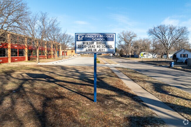There is a sign for Hadley Middle School near the road.