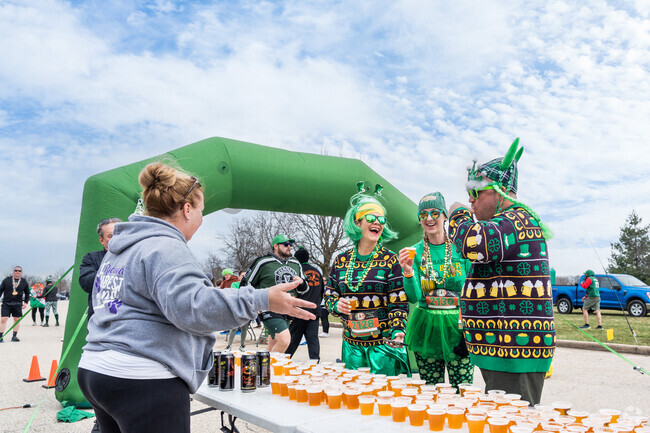 Participants enjoy a beer at the start of the Shamrock Beer Run & Brewfest in Busse Woods.