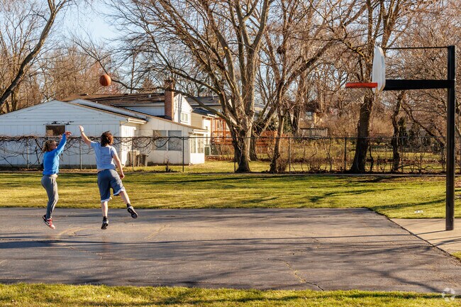 Residents of Hawthorne are playing basketball right in a park across from Metra station.