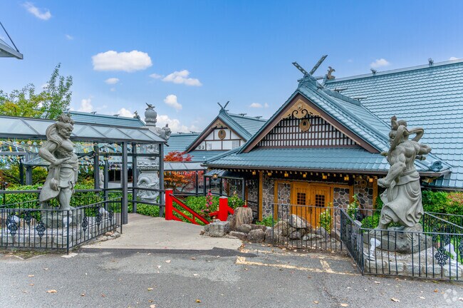 Stone warrior statues flank the path to Mt. Fuji Japanese Steakhouse, a popular hibachi destination in Rockland County.