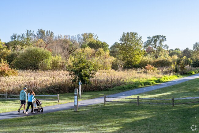 North Oswego residents take a stroll on the Waubonsie Trail through their neighborhood.