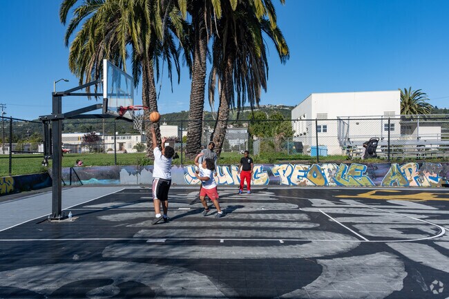 Children play basketball at Concordia Park in the Frick neighborhood.