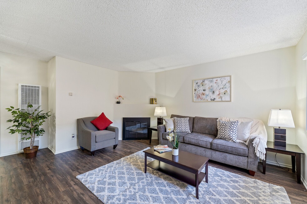 Spacious living room with a fireplace at the Enclave apartment in Studio City