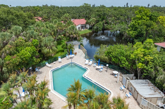 An aerial view of a pool surrounded by homes in El Conquistador.