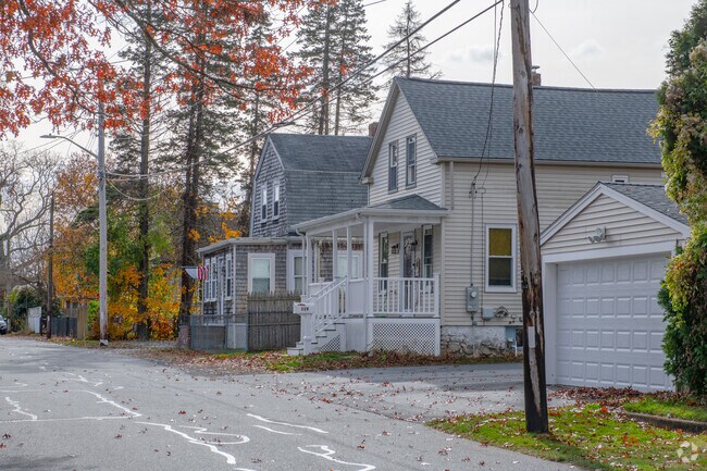 A quiet street in the Acushnet neighborhood has trees separating homes in some places.