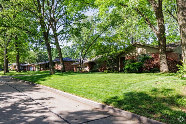 Low slung ranch homes line a tree filled residential street in Brentwood.
