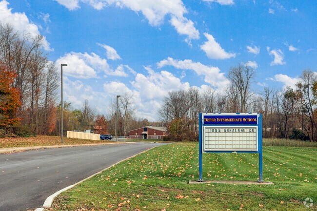 Henry Defer Intermediate Elementary is neatly tucked behind a wooded lot, offering privacy.