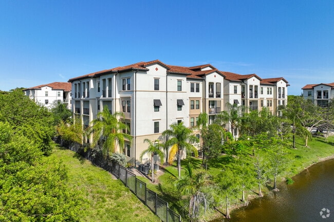 Lake side living in this modern Mediterranean condominium in Highlands neighborhood