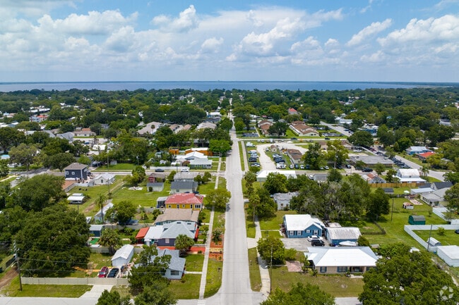 Homes arranged in a grid street system line the shores of Lake Tohopekaliga in Neo City.