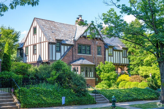 A stately Tudor home with a spacious front and back yard.