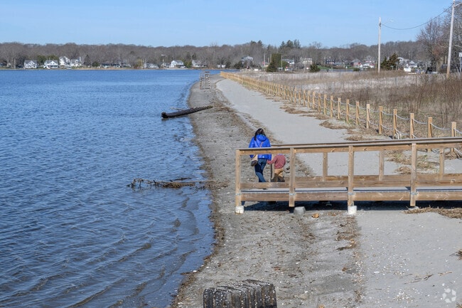 Clambering down from boardwalk to beach, residents of South Swansea enjoy the Town Beach.