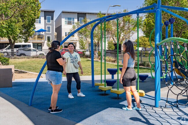 Three Downtown Fresno friends enjoy catching up at the Cultural Arts District Park.