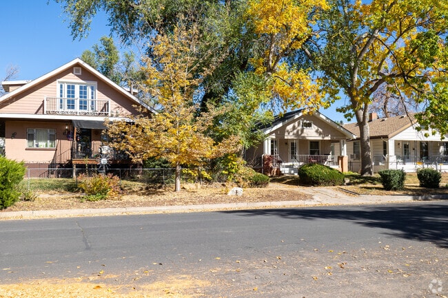 There are large trees in the yards of the Westside neighborhood.