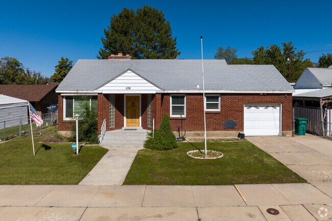 This classic red brick home sits beautifully beneath a blue sky.