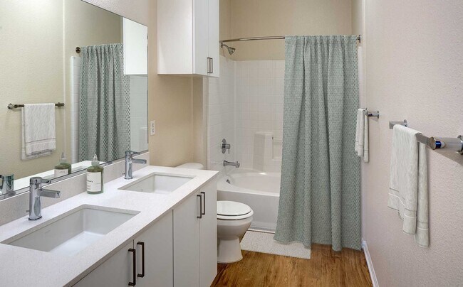 Renovated Package I bathroom featuring white cabinetry, white quartz countertops, and hard surface flooring